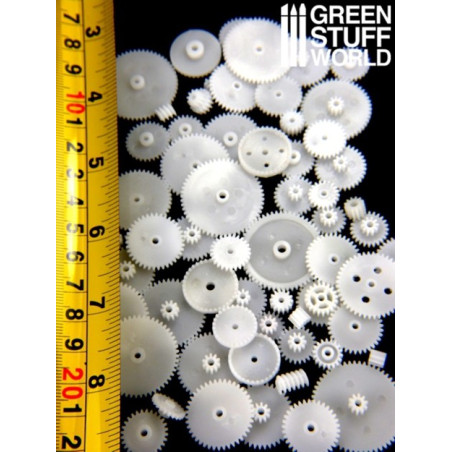 Ingranaggi E Ruote Dentate Di Plastica Bianchi Su Fondo Nero Fotografia